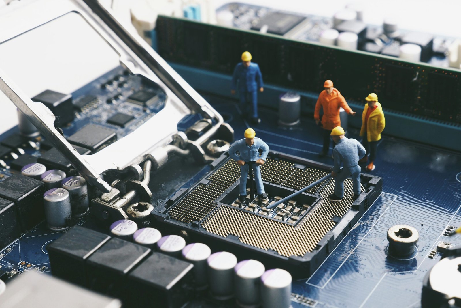 miniature people : engineer and worker working with electronic mainboard computer